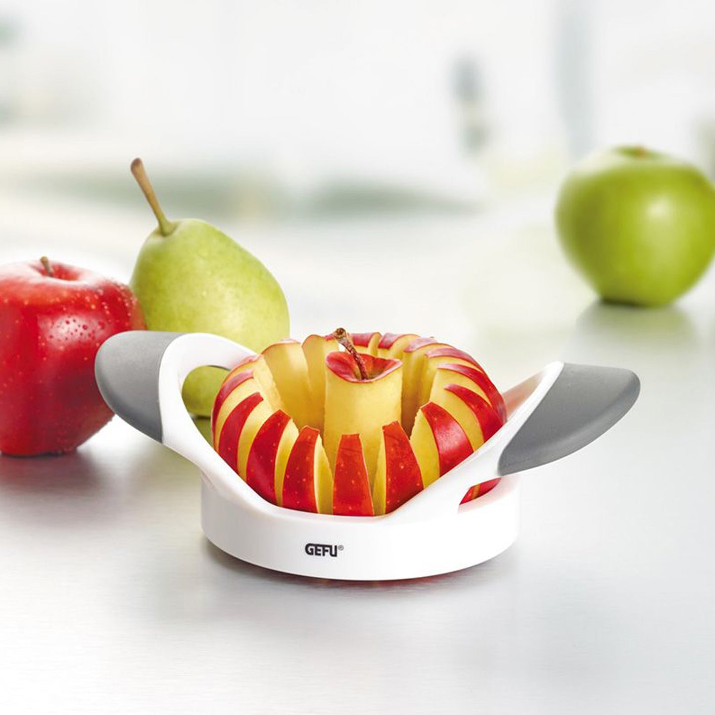 PARTI apple divider with gray handles displaying red-and-yellow apple slices
