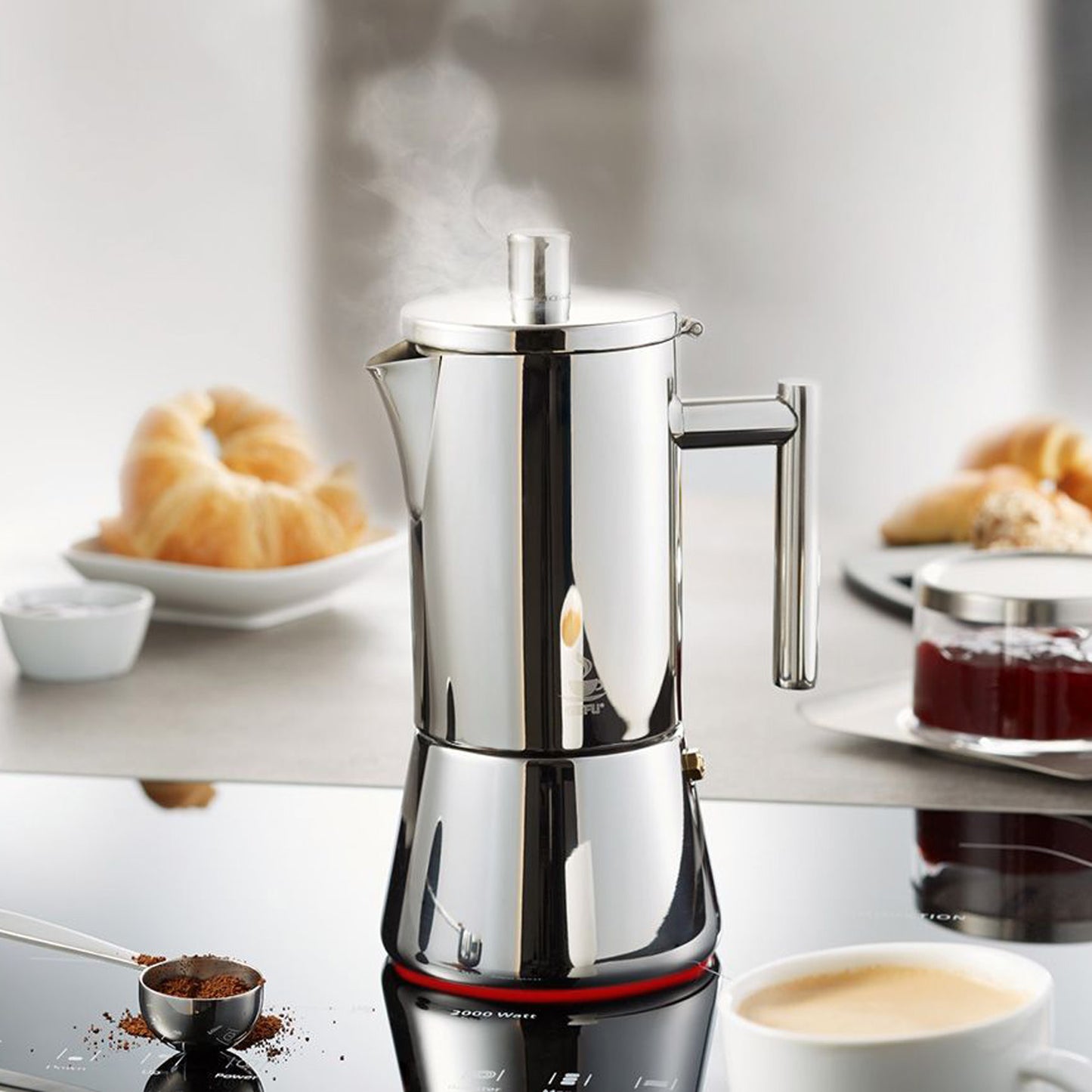 Stainless steel espresso maker with filter cover, side handle, and central steam knob