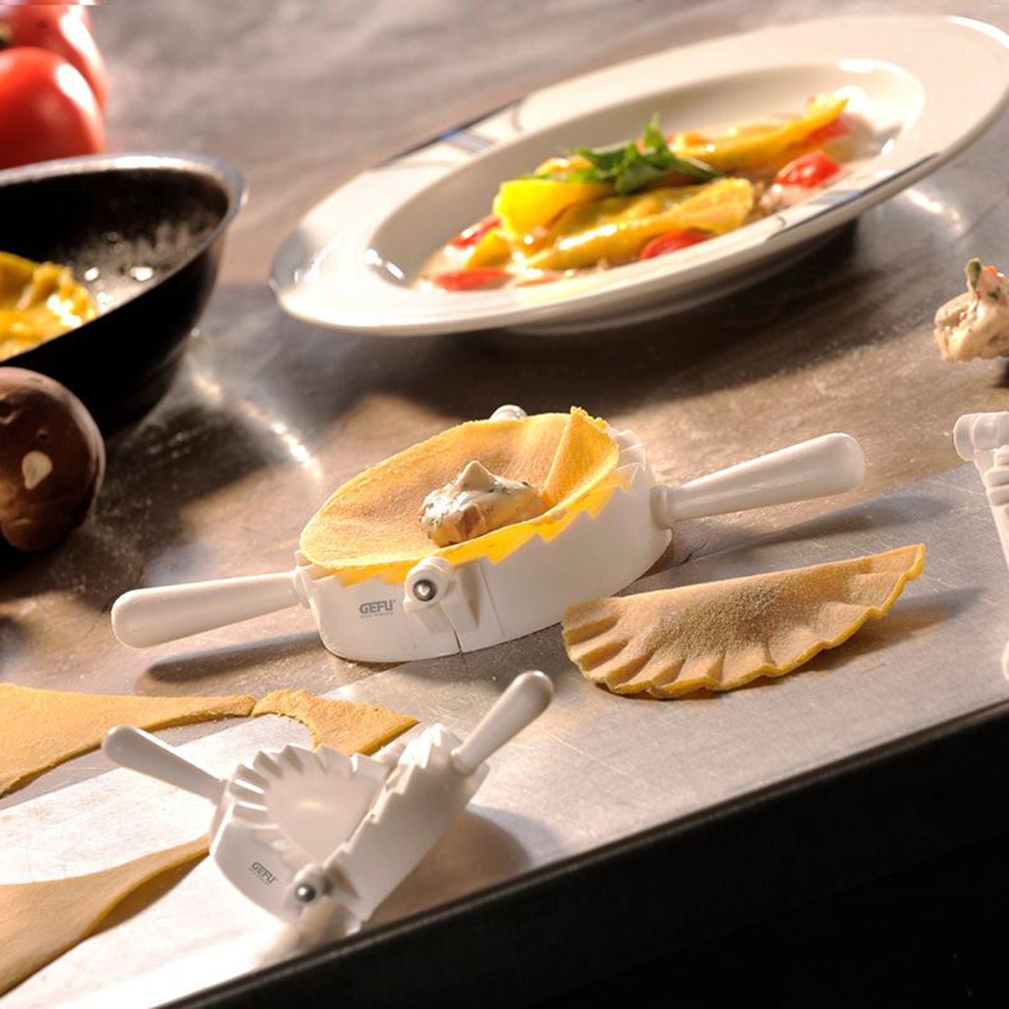 Ravioli mould set on countertop with formed pasta pieces and handles