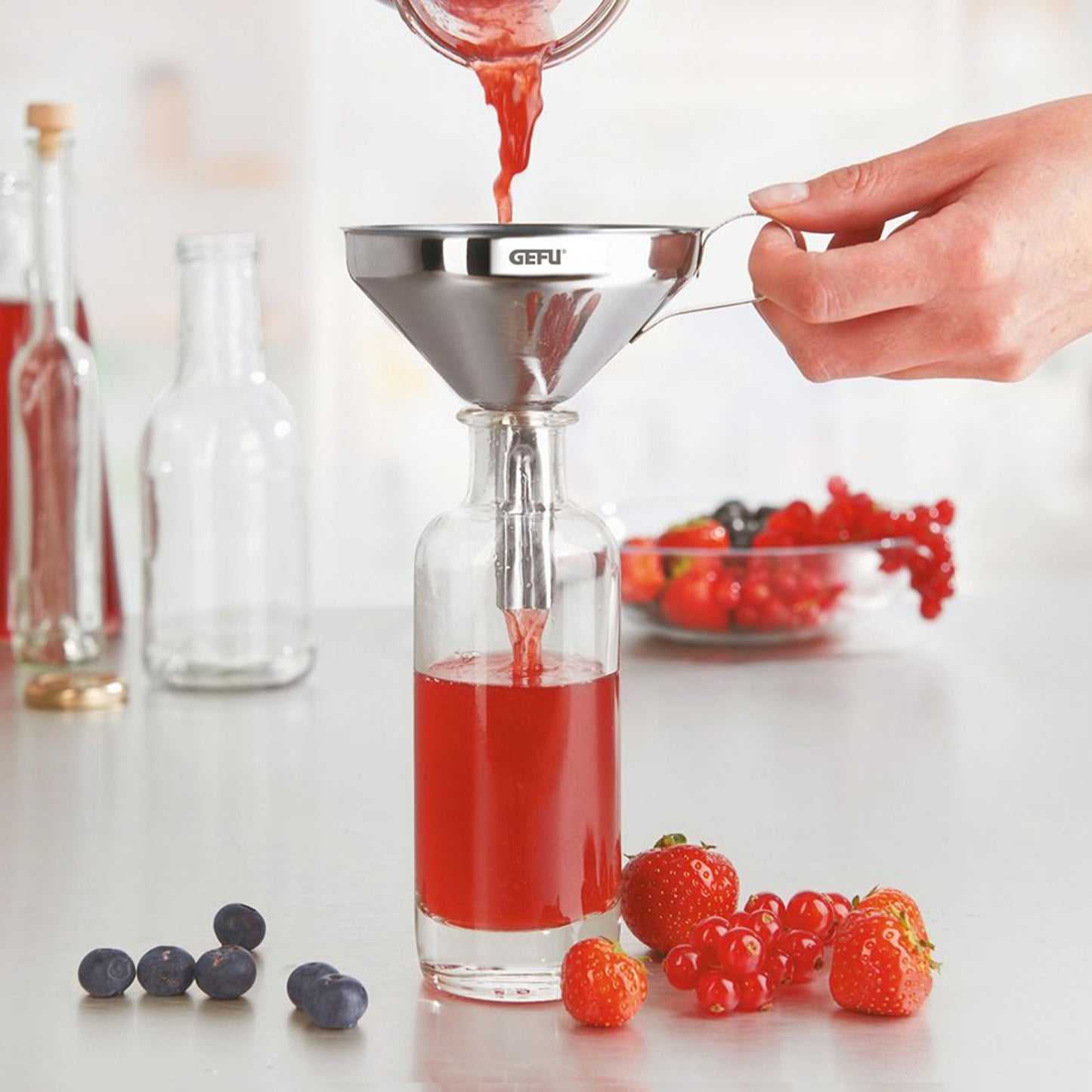 GEFU stainless steel filling funnel with perforated insert on bottle