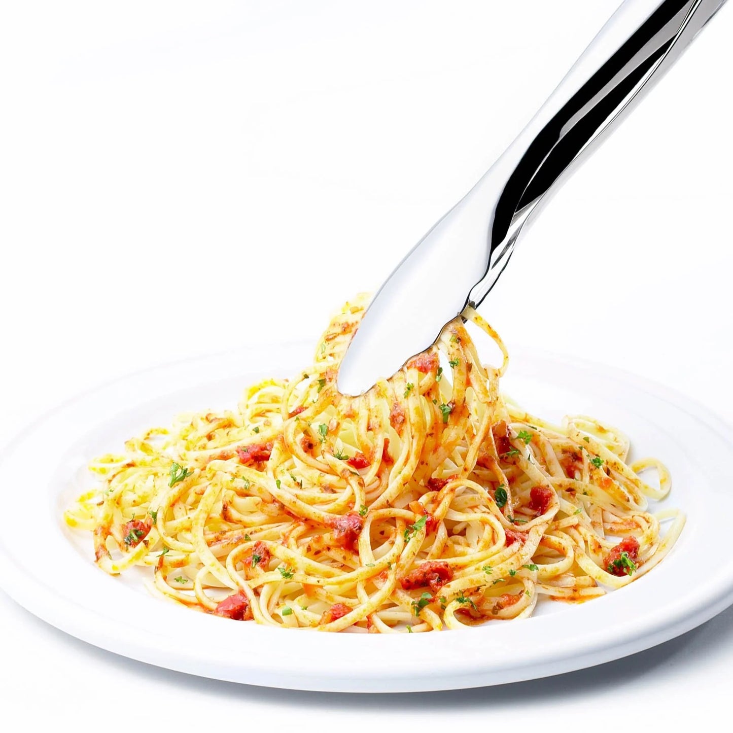 Locking tongs holding spaghetti over a white plate