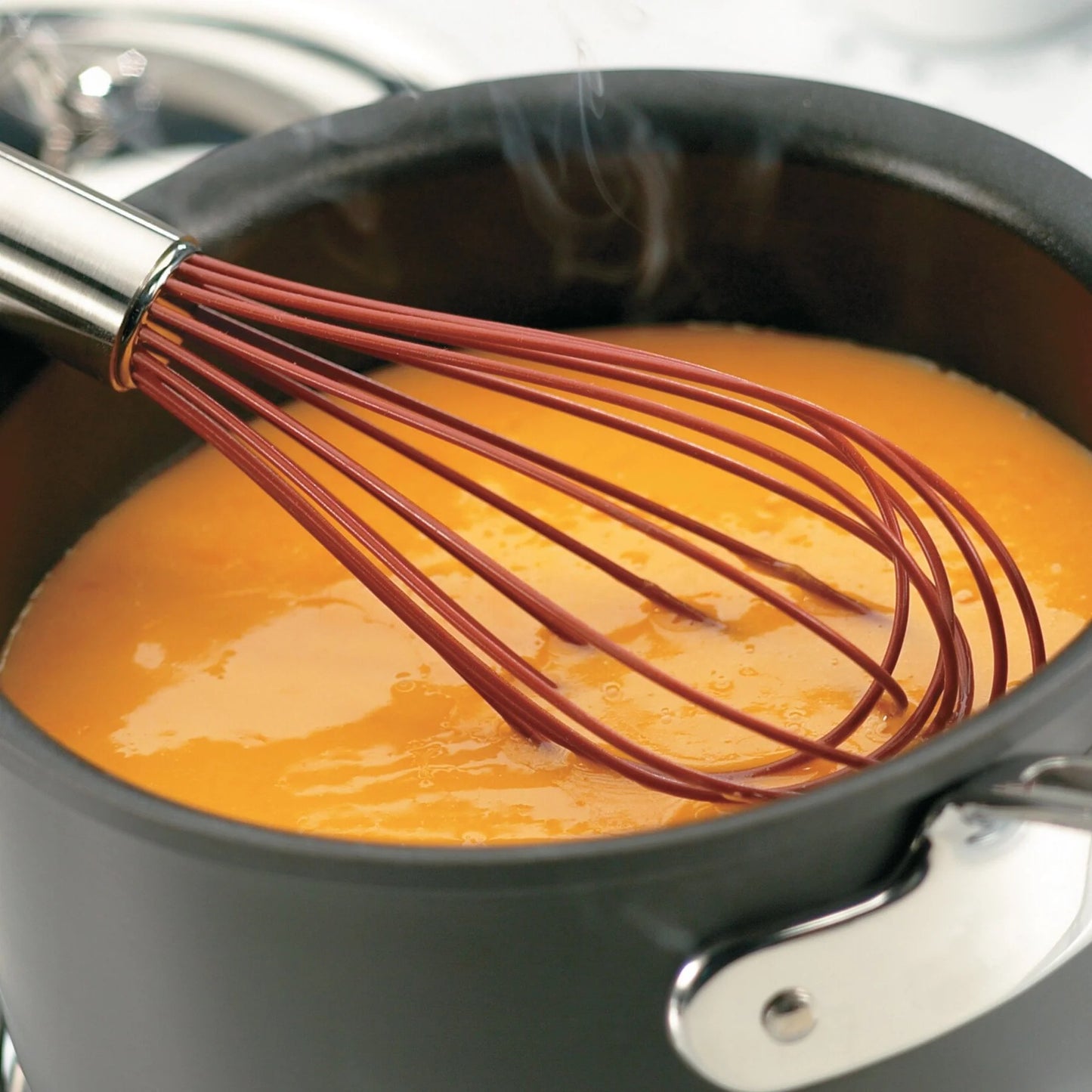 Balloon whisk with brown silicone wire loops and stainless steel handle