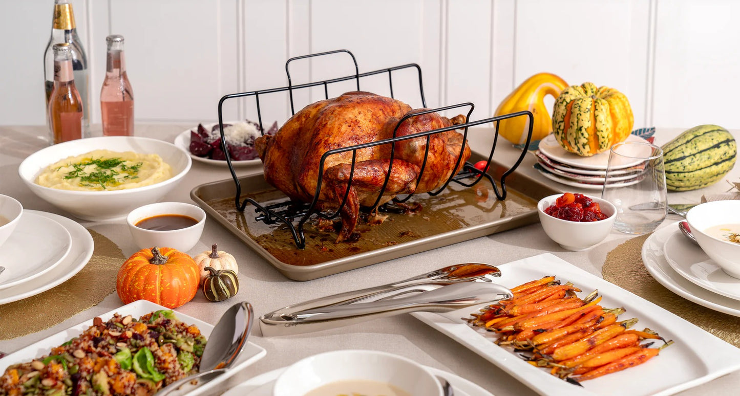 Roasting rack on a dining table with roast chicken and side dishes