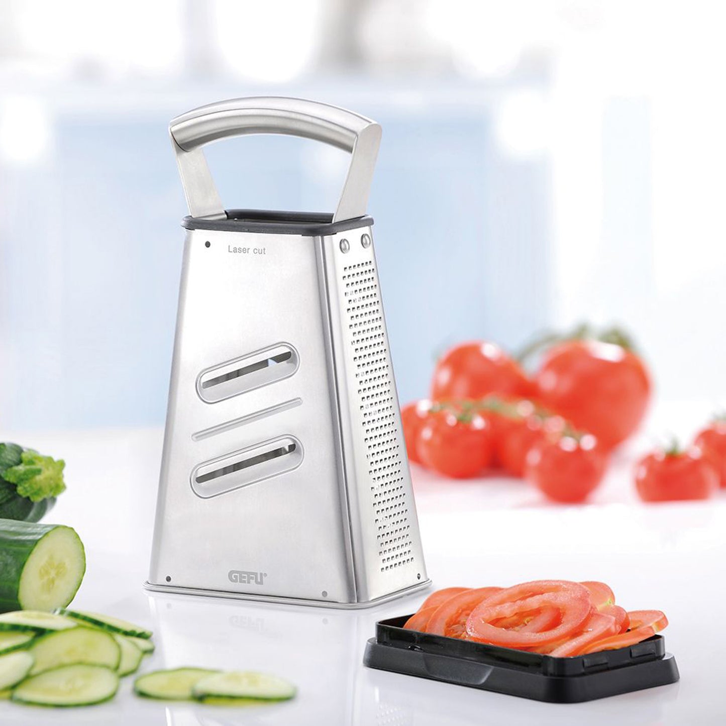 Stainless steel four-way grater with laser-cut grating surfaces and black base