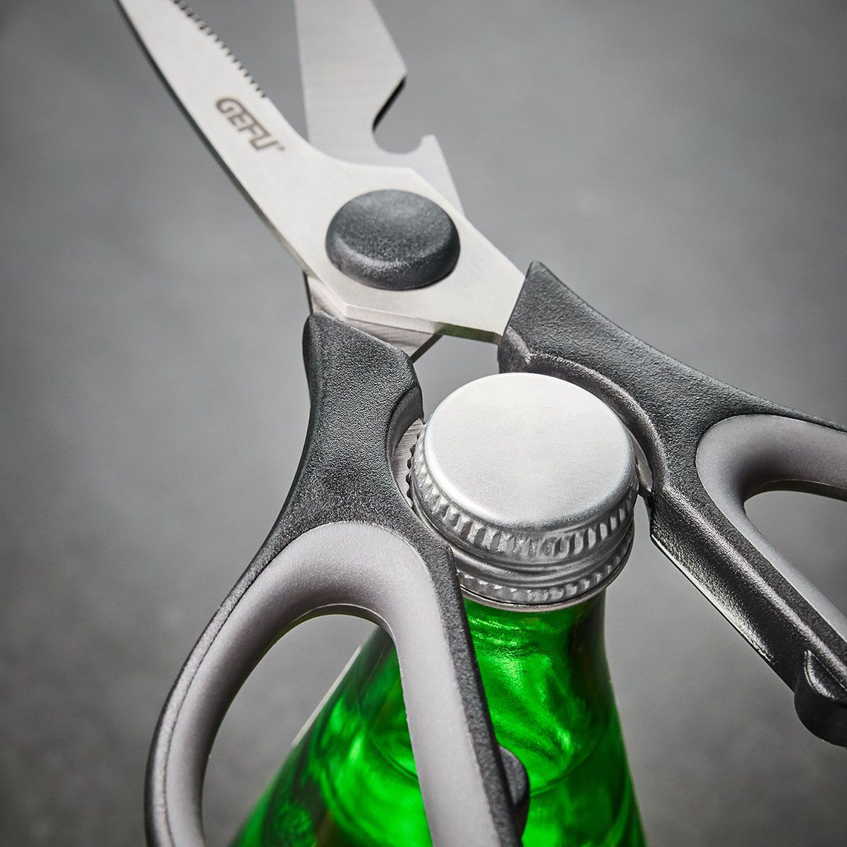 General-purpose scissors close-up with dark handle and toothed cutting edge