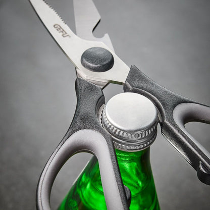 General-purpose scissors close-up with dark handle and toothed cutting edge