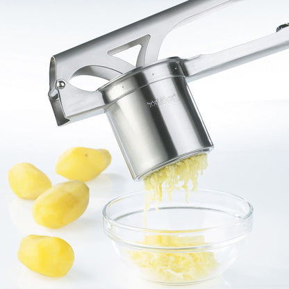 Stainless steel potato & spaetzle press over a bowl with grated strands