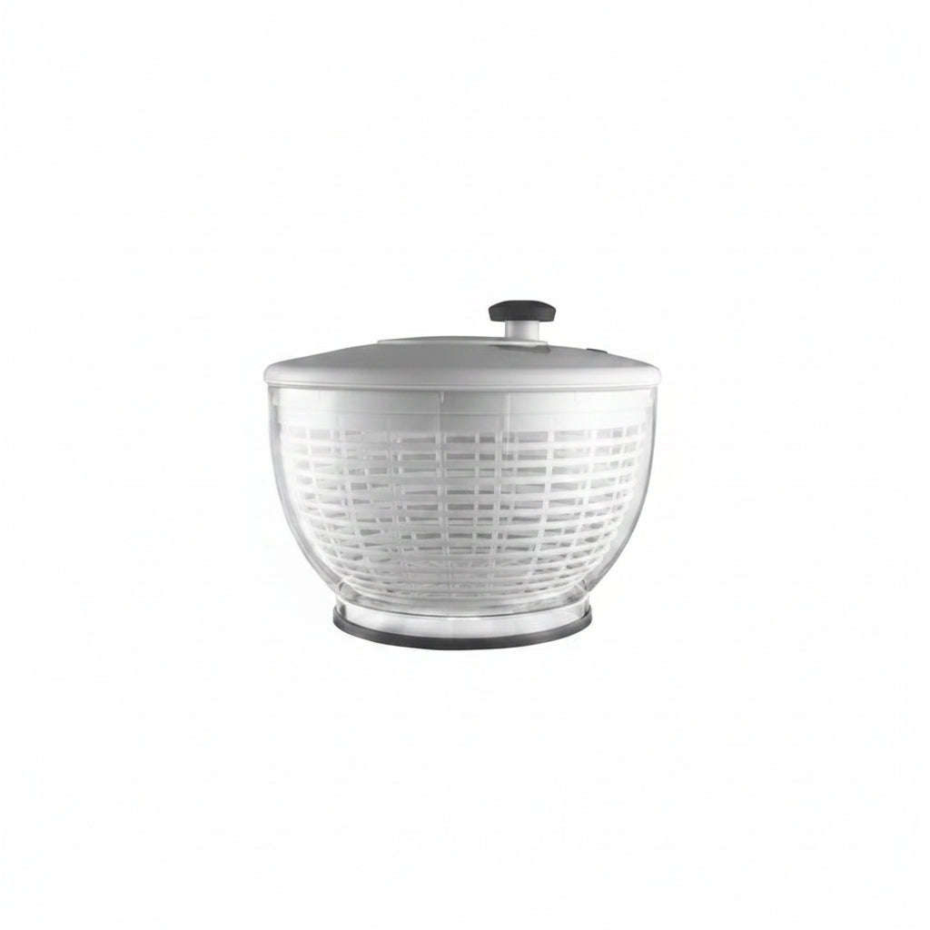 Clear salad spinner with white lid on a white background