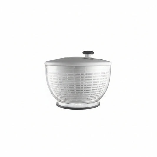 Clear salad spinner with white lid on a white background