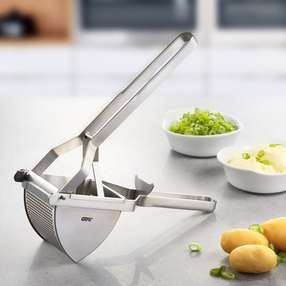 DAS ORIGINAL potato press on countertop beside potatoes and small bowls