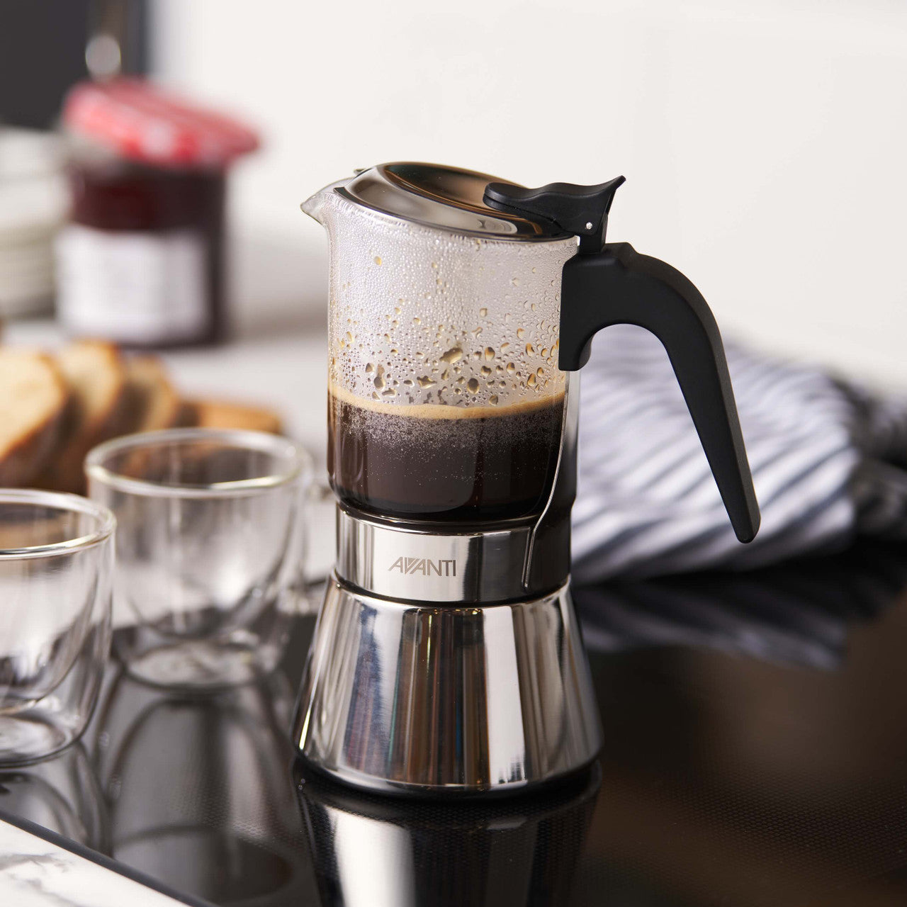 Espresso maker with coffee on a kitchen counter