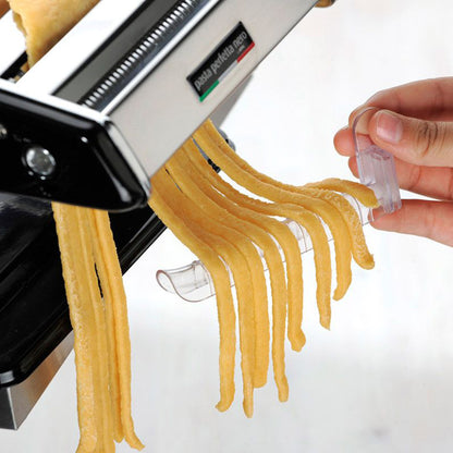 Pasta dryer close-up: hand secures yellow spaghetti onto white clip rack