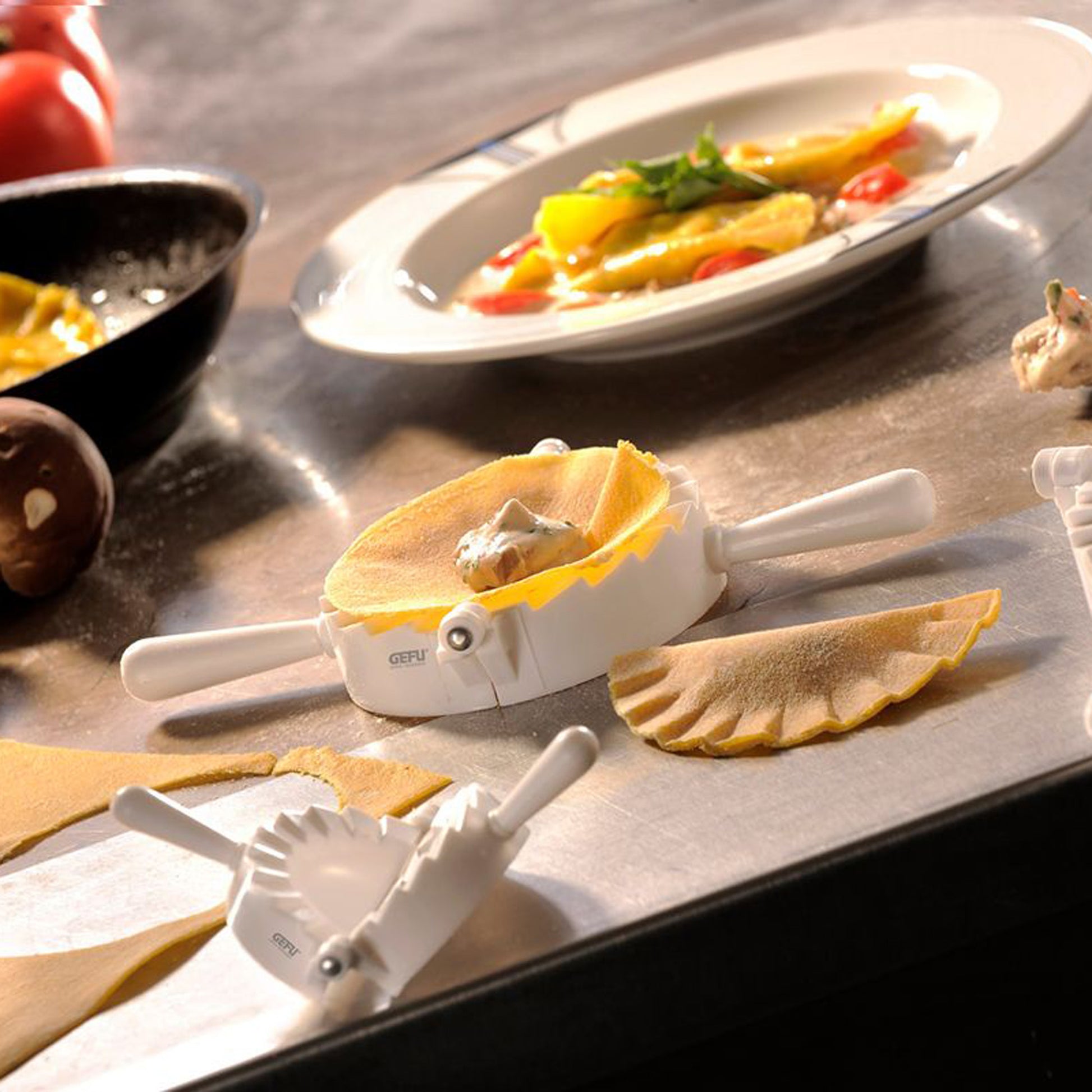 Ravioli mould set on countertop with formed pasta pieces and handles