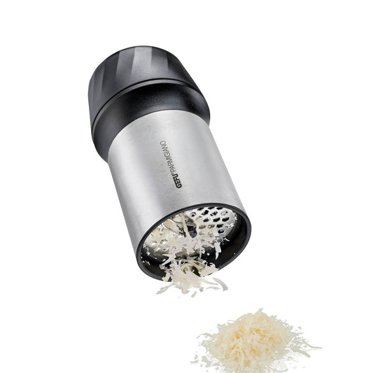 Handheld cheese grater dispensing white cheese shavings; stainless-steel barrel