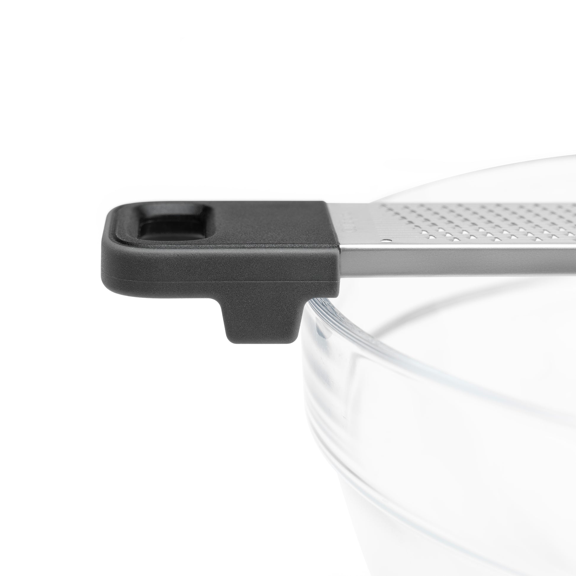 Kitchen grater close-up with black end cap and ridged stainless grating
