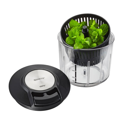 Multi-chopper bowl filled with green mint leaves and black top