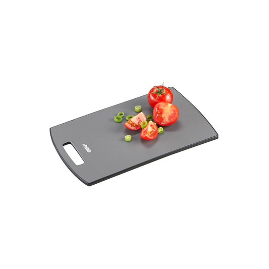 Dark gray cutting board with side hand grip, topped with tomatoes and herbs