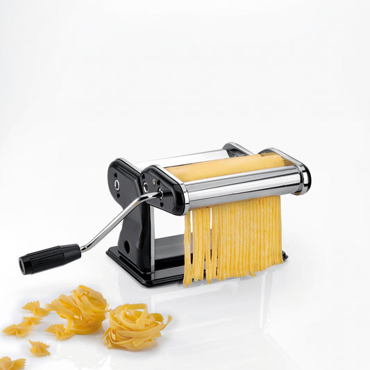 Black and stainless pasta machine with hand crank and long ribbon noodles