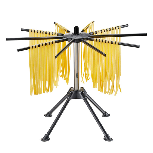 Black metal pasta drying rack with eight arms and yellow hanging pasta strands