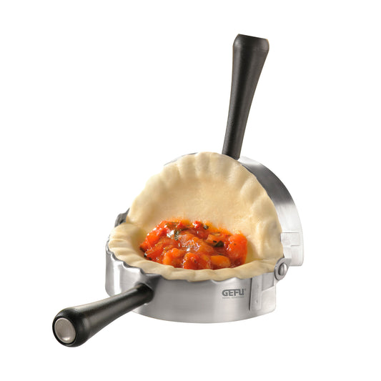 Stainless steel ravioli mold with dough pocket and red filling