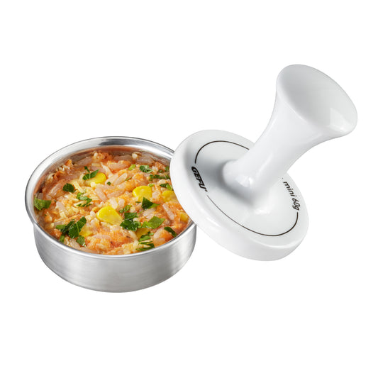 Burger press tool with handle and base, shown beside a bowl of prepared patty mix