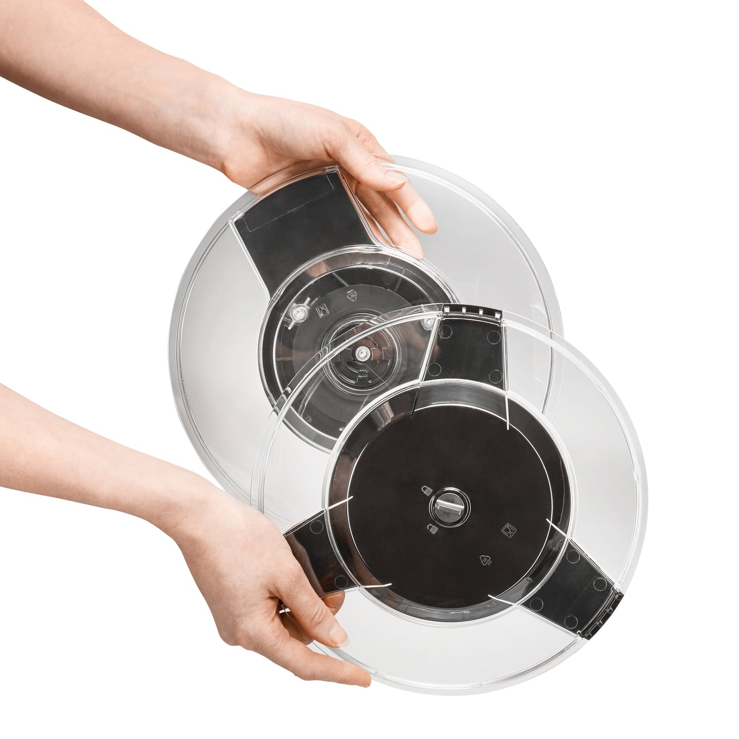 Steel salad spinner lid with internal spinner mechanism, shown with hands