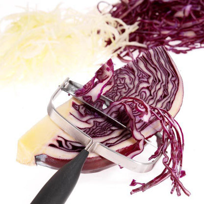 Cheese and vegetable cutter slicing purple vegetables and cheese with black handle.