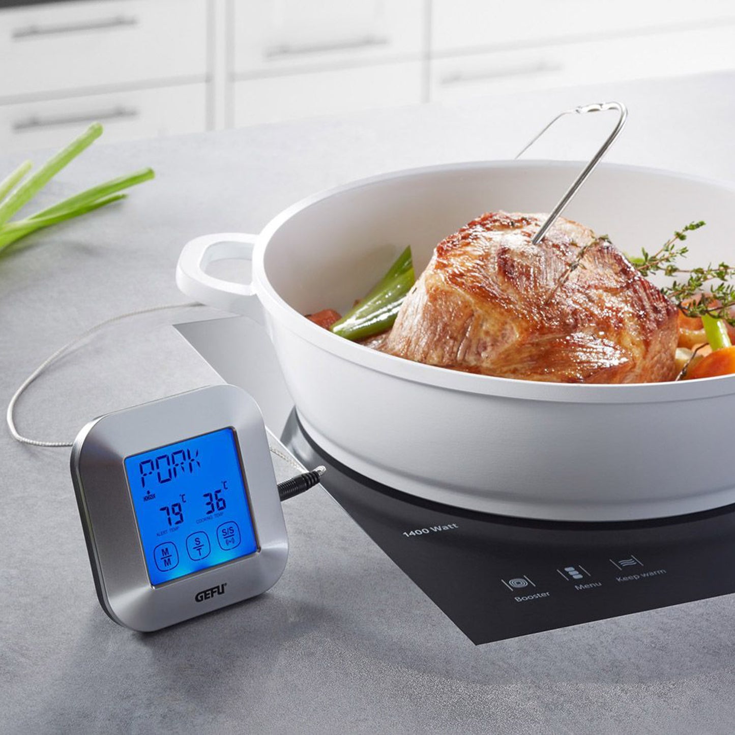 Digital roasting thermometer with timer, LCD display beside roaster; probe inserted in meat.