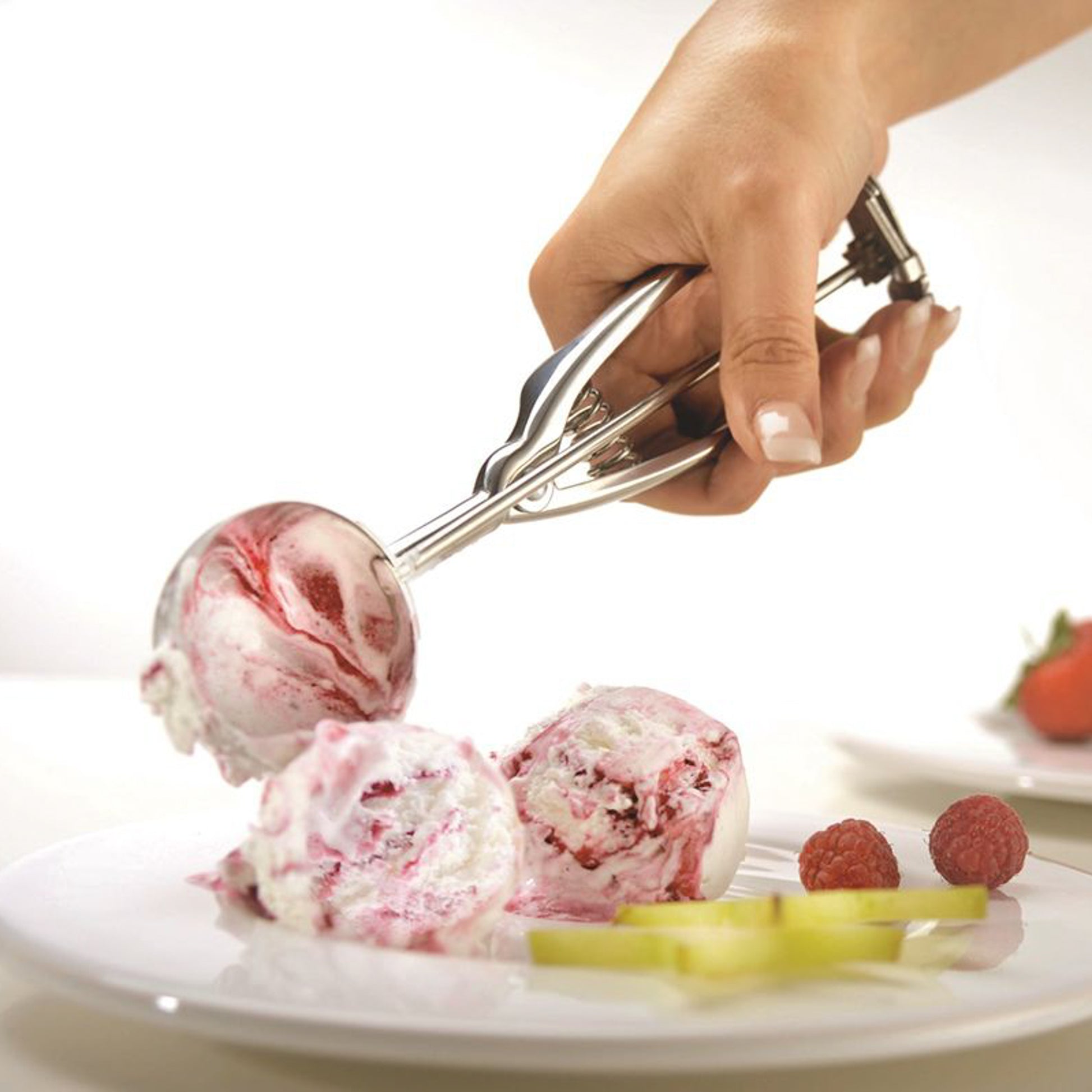 Ice cream scoop held by hand, shaping scoops of ice cream
