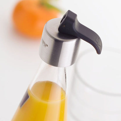 Stainless steel bottle stopper with black silicone handle fitted on glass bottle