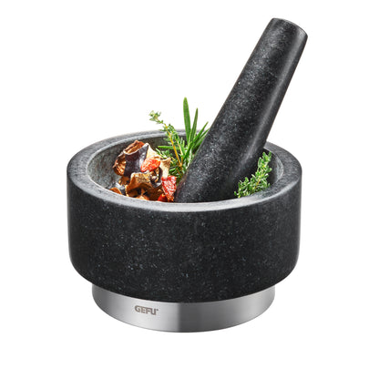 GEFU black stone mortar and pestle with herbs and spices inside