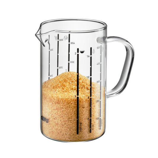 Clear measuring jug with spout, handle, and ml markings; filled with orange grains