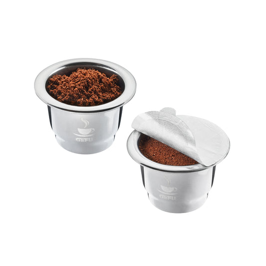 Coffee capsule set with two pods, one opened with grounds visible
