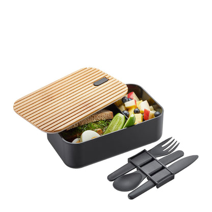 Black lunch box with striped bamboo lid, open with food and separate cutlery