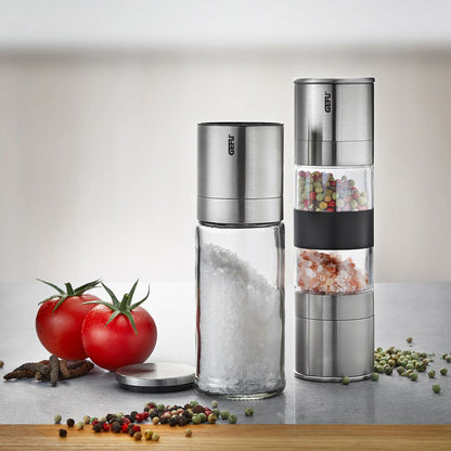 Two stainless steel salt and pepper mills with transparent spice chambers