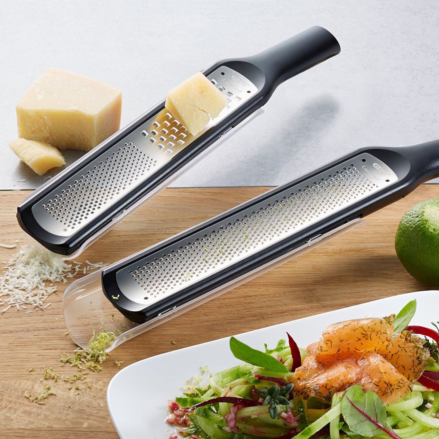 Handheld grater showing fine and coarse holes, grating cheese