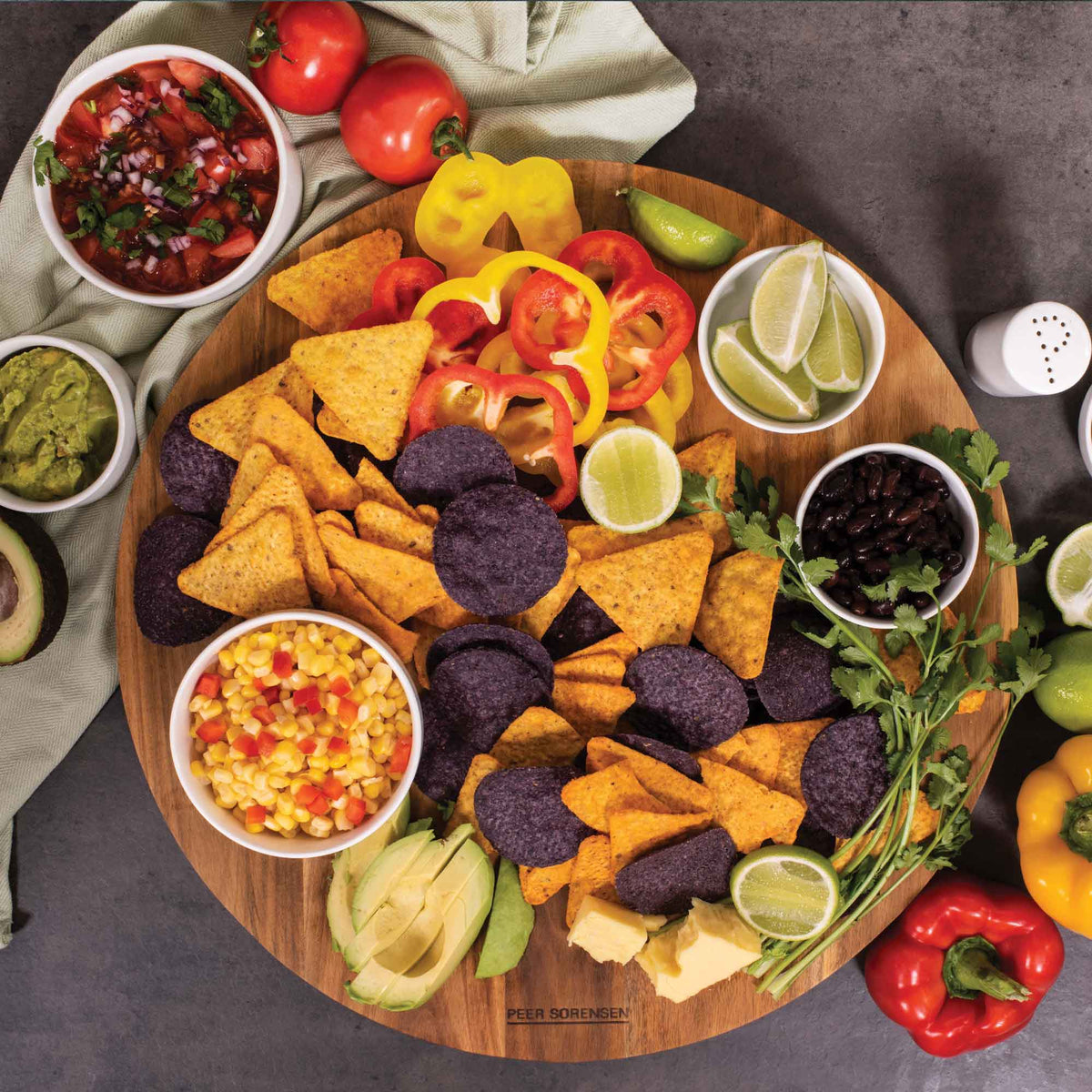 Round wooden lazy Susan cheese serving board with central turntable and assorted snacks