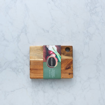 Wooden utility cutting board with hanging hole and an attached product card