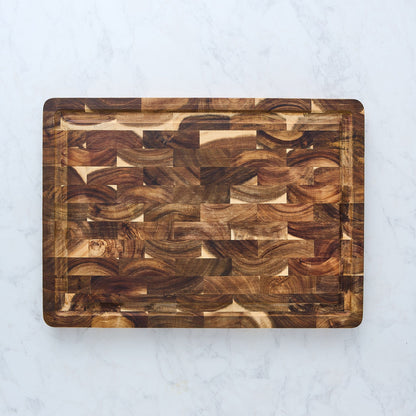 Wooden cutting board with a wavy pattern on a light gray background