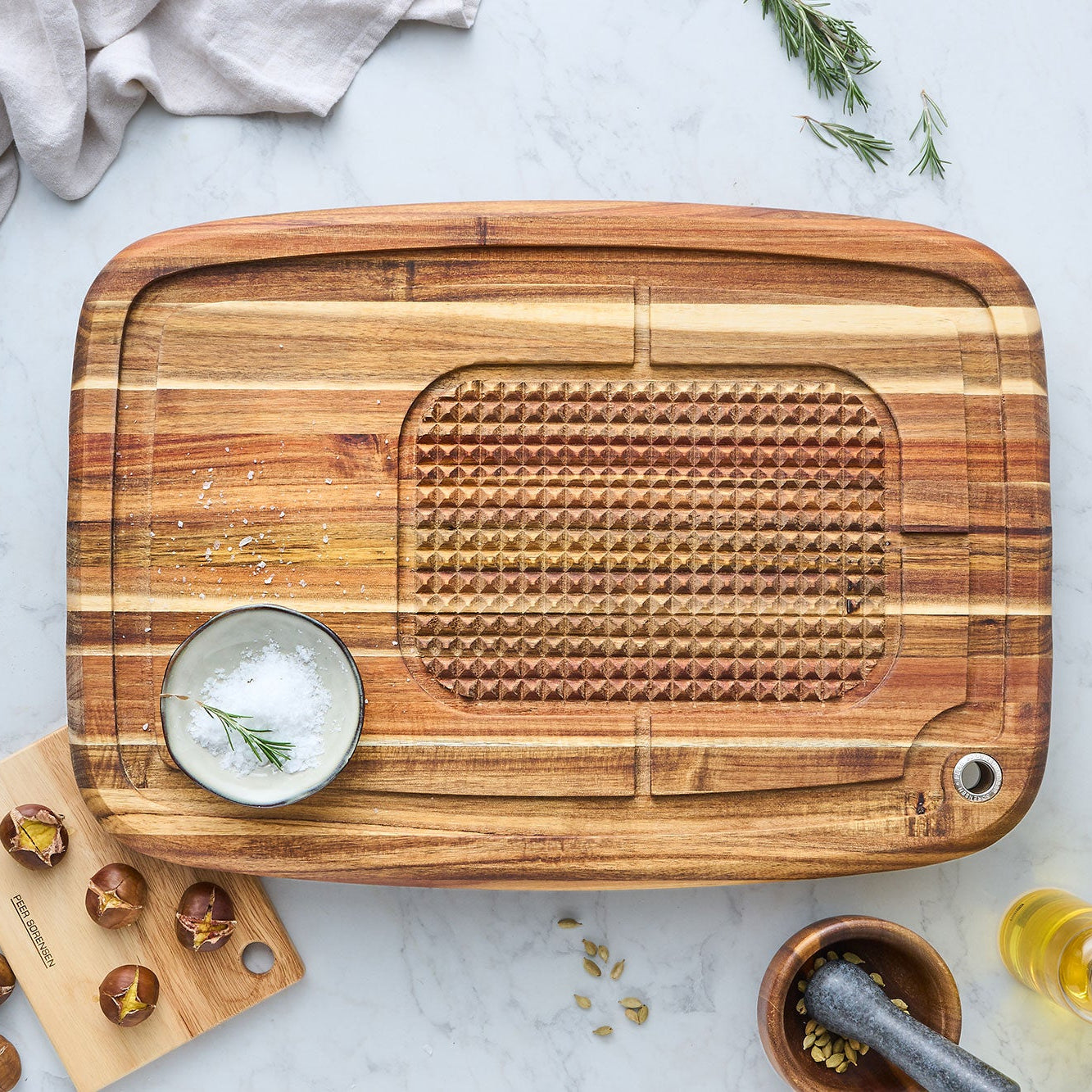 Acacia wood carving board with textured grating section and metal hanging hole