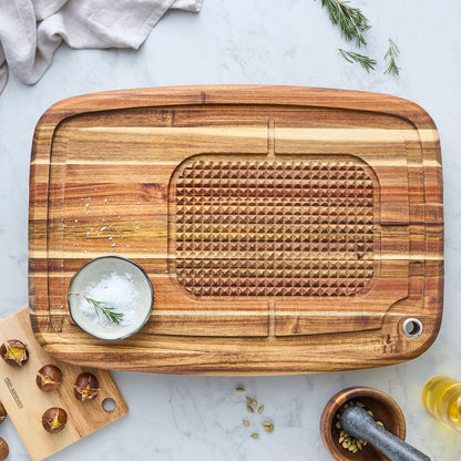 Acacia wood carving board with textured grating section and metal hanging hole