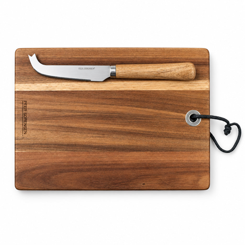 Rectangular wooden serving board with serrated cheese knife laid on top