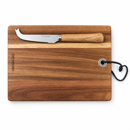 Rectangular wooden serving board with serrated cheese knife laid on top