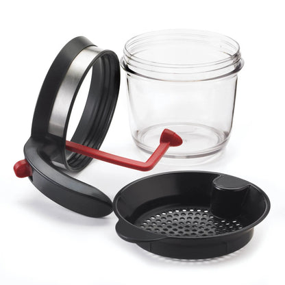 Fat separator set with clear jar, black strainer tray, and red draining lever handle