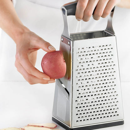 Box grater grating a red potato over the grating tray