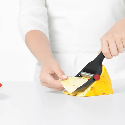 Cheese slicer tool cutting cheese wedge; black body and red adjustment knob