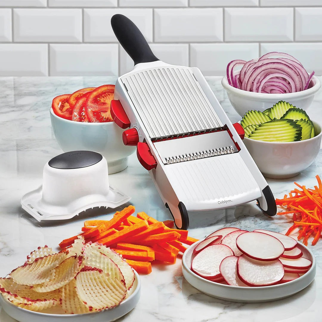 Handheld mandoline slicer with white body, black handle, and red side lever.