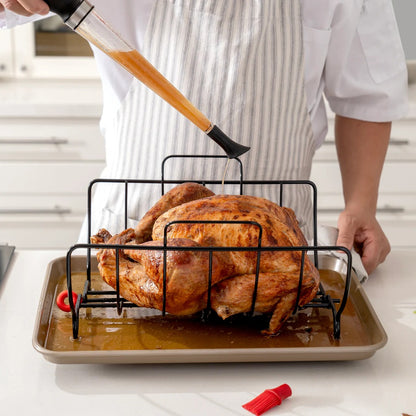Turkey baster applying drippings to roasted chicken over a metal roasting tray