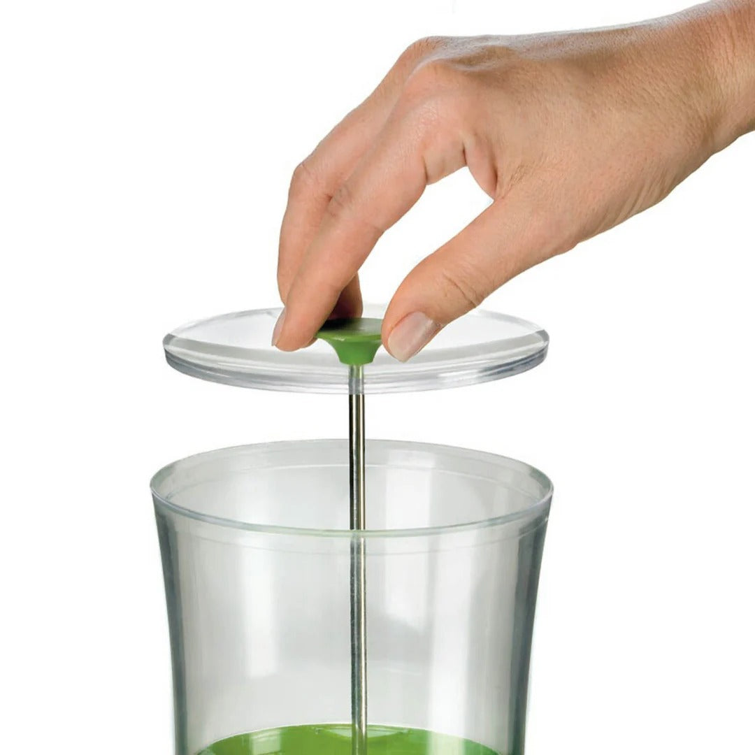 Hand pressing green knob on clear lid of glass herb jar for sealing