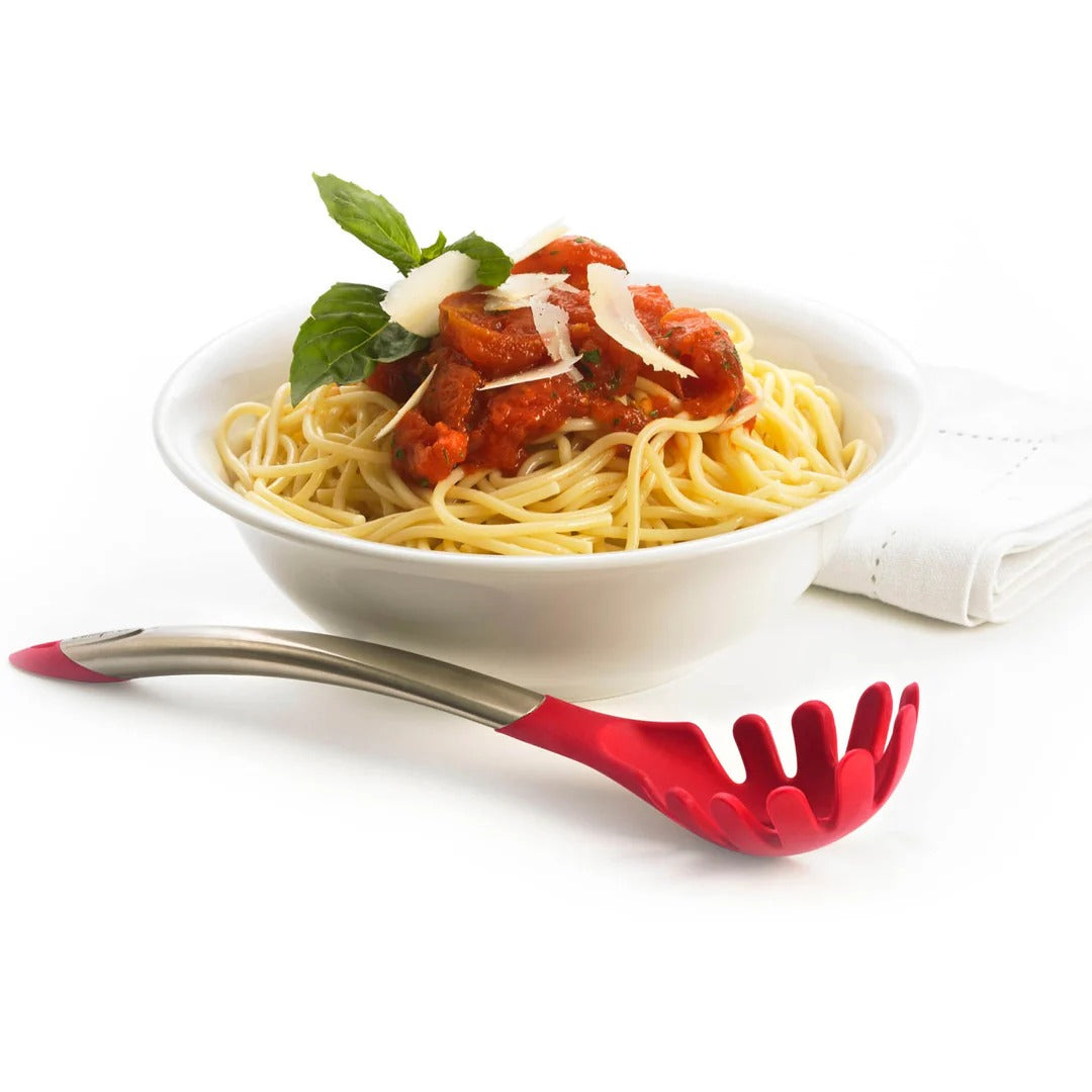 Silicone spaghetti server lying on a bowl of pasta, red skimmer head visible